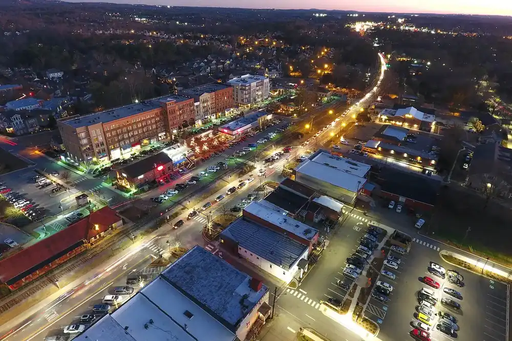 Aerial view at dusk of downtown Woodstock, Georgia, with lit streets and brick buildings